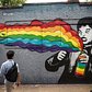 A man walks past a mural painted on the '5 Pointz' building on August 9, 2013 in the Long Island City neighborhood of the Queens borough of New York City.