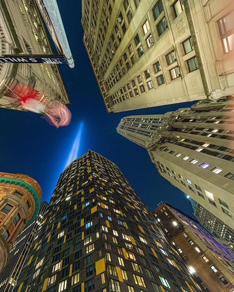The @911memorial Tribute in Lights of the @wtc seen from the tight cluster of tall skyscrapers in the Financial District