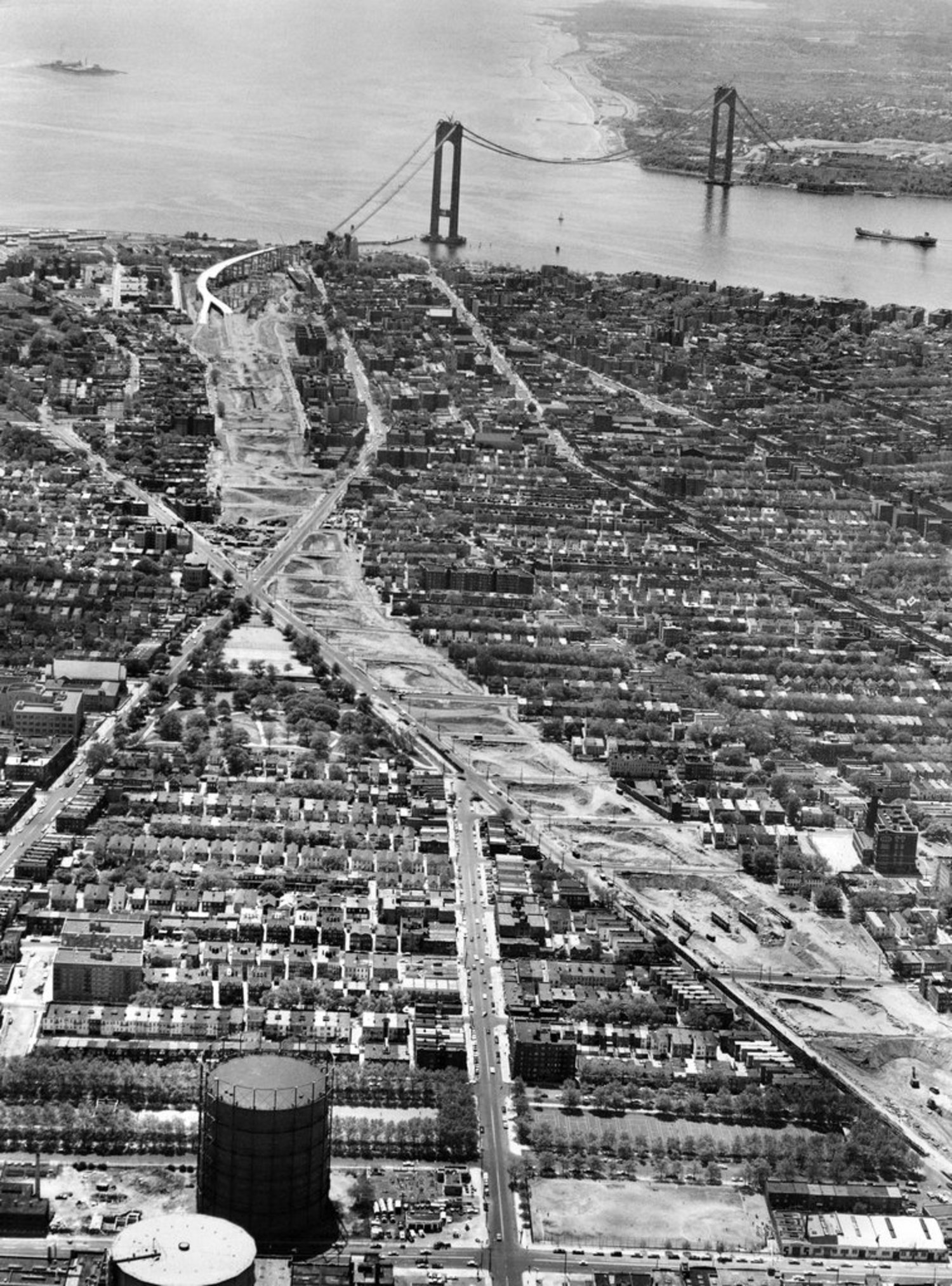 May 17, 1963: A view of sleepy Staten Island and “The Bridge — the $325,000,000 Verrazano-Narrows span, which will join Fort Wadsworth on the island with Fort Hamilton in Brooklyn when it is completed.” The booming growth of the island chagrined some, who “gloomily forecast intolerable overcrowding of schools, stores, living space and roads. They are less sanguine than the enthusiasts about the solution of such problems as lack of sewers, of final mapping and paving of streets and of ‘City Hall red tape’ that discourages prospective industrial development.”