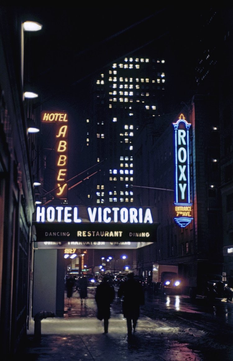 1946 New York street showing the Hotel Abbey, Hotel Victoria and the Roxy in Times Square. In the background is the Rockefeller Center.