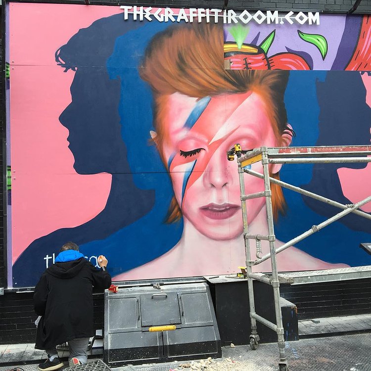Artist painting his signature. #ripdavidbowie #nyc #newyorkcity #soho 