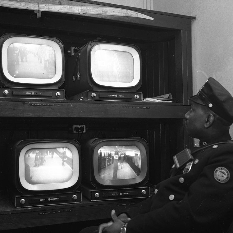 1960's: Transit Authority Patrolman Harold Reed has his eyes glued on TV monitors that provide different views of the 14th St. subway station in order to alert police of problem areas and deter crime.