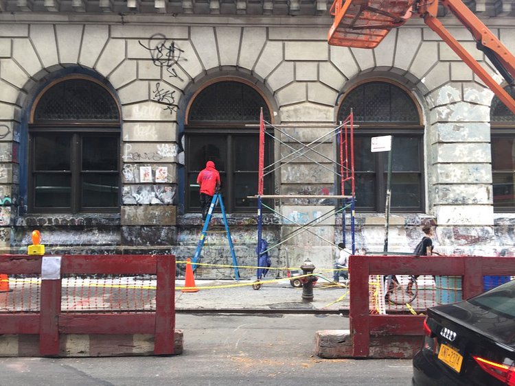 They’re removing the graffiti from 190 Bowery.