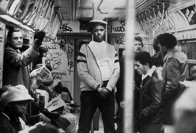 1980's: A member of the volunteer crime-fighting organization, the Guardian Angels, patrols a subway car in the 1980s. The organization was both praised and vilified by the media for its efforts. 