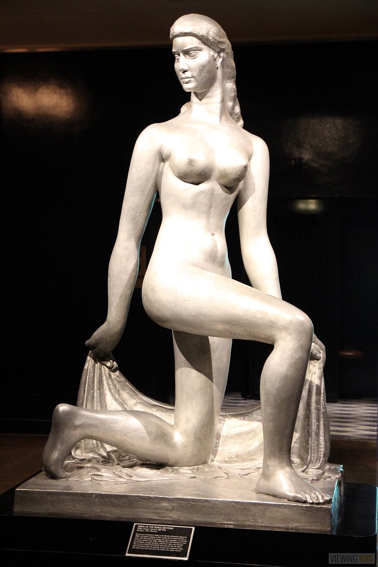 Spirit of the Dance Sculpture | Built in 1932, Radio City Music Hall is a prime example of art deco architectural style that has withstood the test of time. With tons of gold, reflective surfaces and geometric design, walking through the venue is a bit like stepping back in time. Most of the fixtures, furniture and ornamentation are original, and any replacements are exact replicas of how the theater looked 80 years ago.

Read more here: <a href="https://viewing.nyc/i-braved-a-walkthrough-of-radio-city-music-hall-meant-for-tourists/" rel="nofollow">viewing.nyc/i-braved-a-walkthrough-of-radio-city-music-ha...</a>