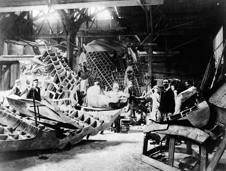 View of portions of the Statue of Liberty during its construction in the workshop of French sculptor Frederic Auguste Bartholdi (seen at left) in Paris circa 1880.