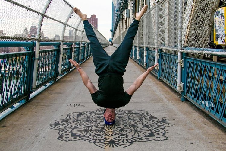 A yoga headstand on the Manhattan Bridge