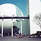 People visit the Trylon and Perisphere at the 1939 New York World's Fair. Inside the Perisphere was a diorama of a futuristic utopian city named Democracity. After viewing, visitors would leave by descending a long spiral walkway named the Helicline.