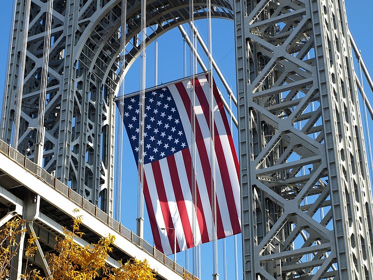George Washington Bridge - 2008 Veterans Day | The George Washington Bridge is home to the world's largest free-flying American flag. The flag, which is located under the upper arch of the New Jersey tower, drapes vertically for 90 feet and flies freely, responding to breezes from the Hudson River or Palisades. The flag's stripes are approximately 5 feet wide and the stars measure about 4 feet in diameter. Weather permitting, the flag is flown on the following eight holidays: Martin Luther King, Jr. Day, Presidents Day, Memorial Day, Flag Day, Independence Day, Labor Day, Columbus Day, and Veterans Day [Source: The Port Authority of New York and New Jersey]