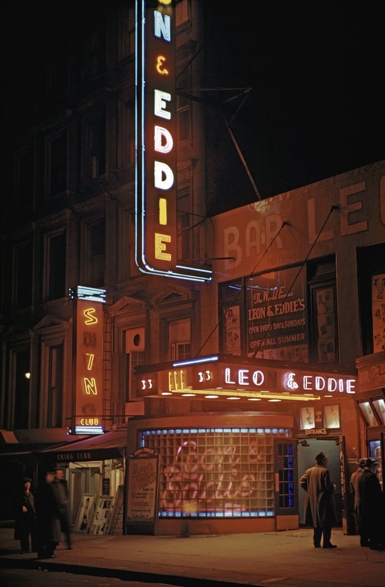 1946 Leon and Eddie's nightclub on 52nd street in Times Square (midtown) at night with patrons hanging out on the sidewalk.