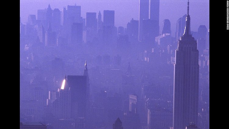 A purple haze enshrouds the city in 1989, with the Empire State Building in the foreground and the Twin Towers in the background.
