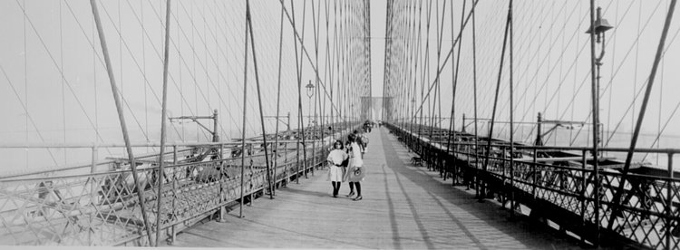 Pedestrians on the upper deck promenade of Brooklyn Bridge