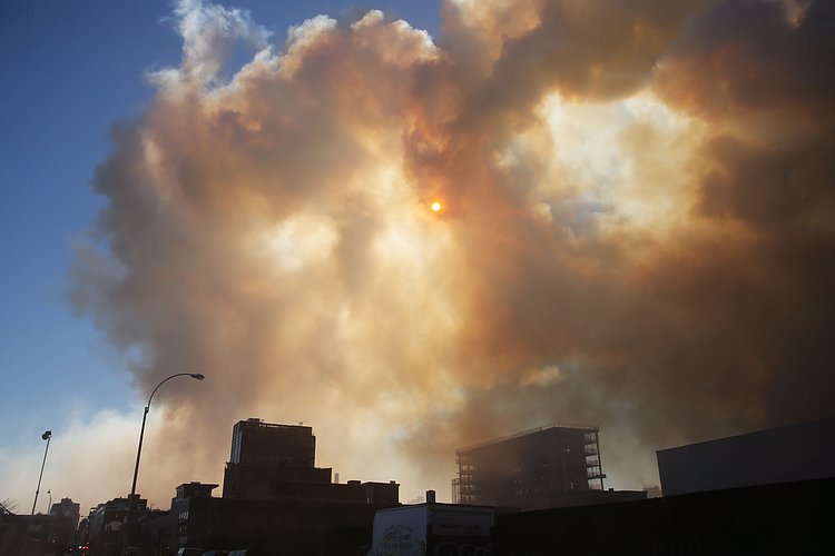 Firefighters continued pouring water on the remains of a 7-alarm fire in a warehouse on the Williamsburg waterfront