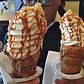 coneCHURRO!® NYC! 1:30pm - midnight, daily.  Lookout for additional MAY FLAVORS!! *Banana Brûlée *Strawberry Shortcake, *Nutella S'mores Galore!!! Pictured: Jheri curl.  Photo cred: _worththeweight_
JHERI CURL - sea salt caramel coated inner cone, cinnamon struessel rim with sea salt caramel drizzle.

NUTTY PROFESSOR:  nutella smeared "inner" cone with brown sugar pecan rim, world's tastiest tahitian vanilla bean soft serve with toasted almonds, nutella drizzle and frosted pecan top.

TWINKLE SPRINKLES:  66% Valrhona caribe chocolate ganache coated inner cone with happy dance rainbow sprinkles.

POINDEXTER:  66% Valrhona caribe chocolate ganache coated inner cone with happy dance rainbow sprinkled RIM.

CHOCO-RASPBERRY SUNDAE:  chocolate ganache/raspberry jam filling, chocolate struessel rim, raspberry and chocolate sauce drizzle. 
GREEN ENVY:  red bean inner cone, green tea struessel rim, green tea/vanilla swirl, red bean top. 
204 E. 10th st. @2nd Ave., NYC, BITCHESSSZz.  conechurro.com