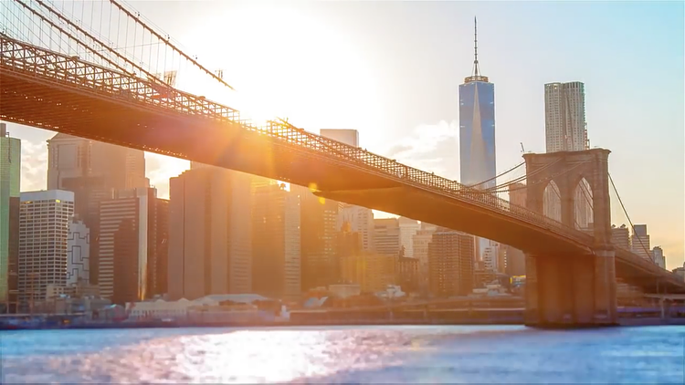 From Brooklyn Bridge Park, we get a look at the world-famous suspension bridge. Completed in 1883, the bridge was designated a National Historic Landmark in 1964. Just behind, the 1,776-foot height of One World Trade Center marks the highest peak in the skyline as the sun sets behind the Manhattan skyscrapers. 