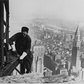 Workman, perched on the end of a beam, bolting together the framework of the Empire State Building, New York City, 1930. Photograph by Lewis Hine