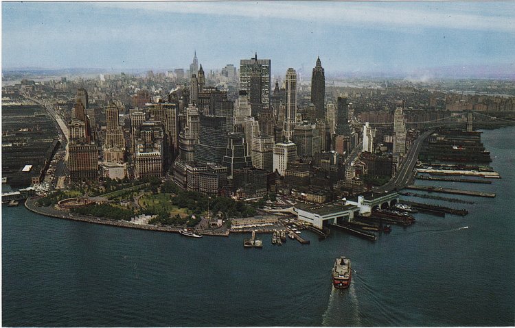 The Staten Island Ferry is arriving as Manhattan’s classic skyline is seen from the south c 1963