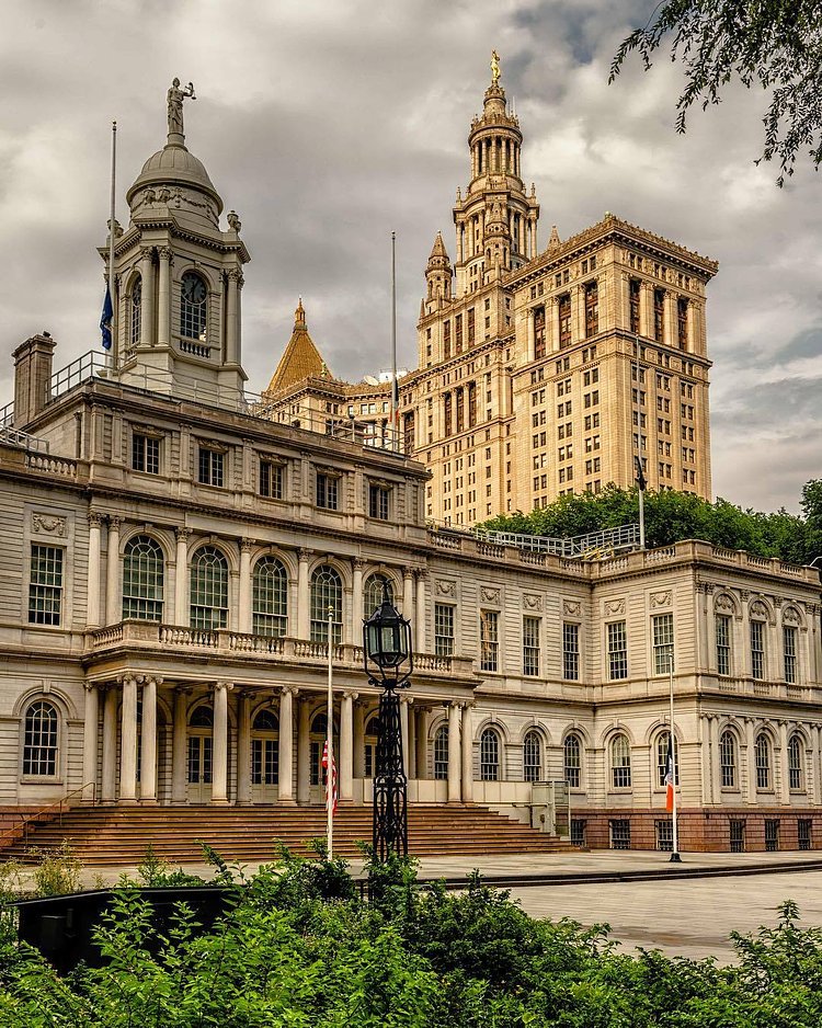 Municipal Building shining behind City Hall. The City was in desperate need of office space in the late 1880s. The various departments outgrew the small confines of City Hall. There was even talk of tearing down City Hall to erect a modern office building. The proposal was immediately met with enemies, one calling it an "act of vandalism." Preservation won out in the end and City Hall is the oldest active government building in the city, built in 1811.