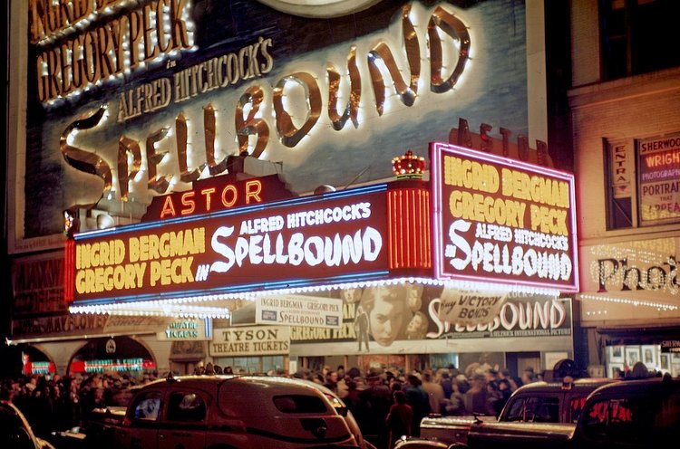 1946 View of crowds under the marquee of the Astor Theater lined up to see the Alfred Hitchcock film "Spellbound". The view looks north-east across Broadway, near West 45th Street.