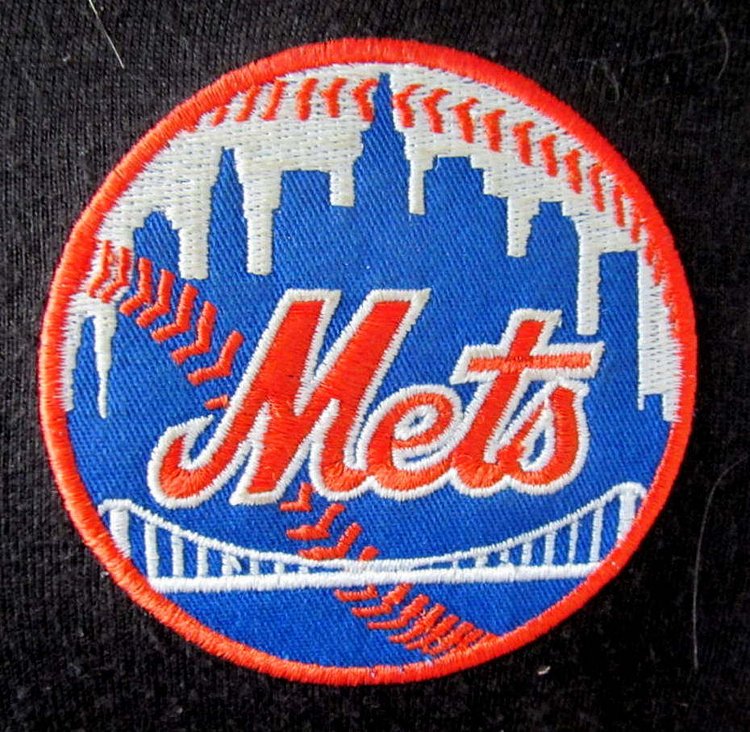 METS..... | Are a team based in the New York City borough of Queens. They play in Major League Baseball's National League East Division. This was a patch on a person's sweat jacket that I saw while waiting on a checkout line at the Shop Rite supermarket in Carmel, New York.