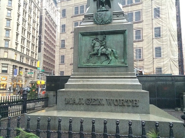 Traffic and pedestrians rush passed it all day