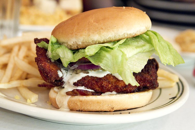 chicken sandwich with fries | <a href="http://piesnthighs.com/" rel="nofollow">Pies 'n' Thighs</a>

Fried chicken cutlet with lettuce, tomato, onion, avocado, with some...creamy sauce stuff. It's pretty great.