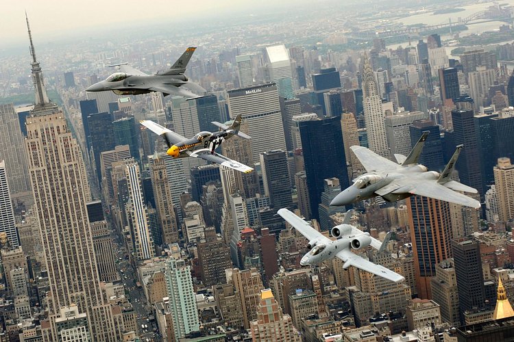 F-16, P-51, A-10 and an F-15 flying above New York City