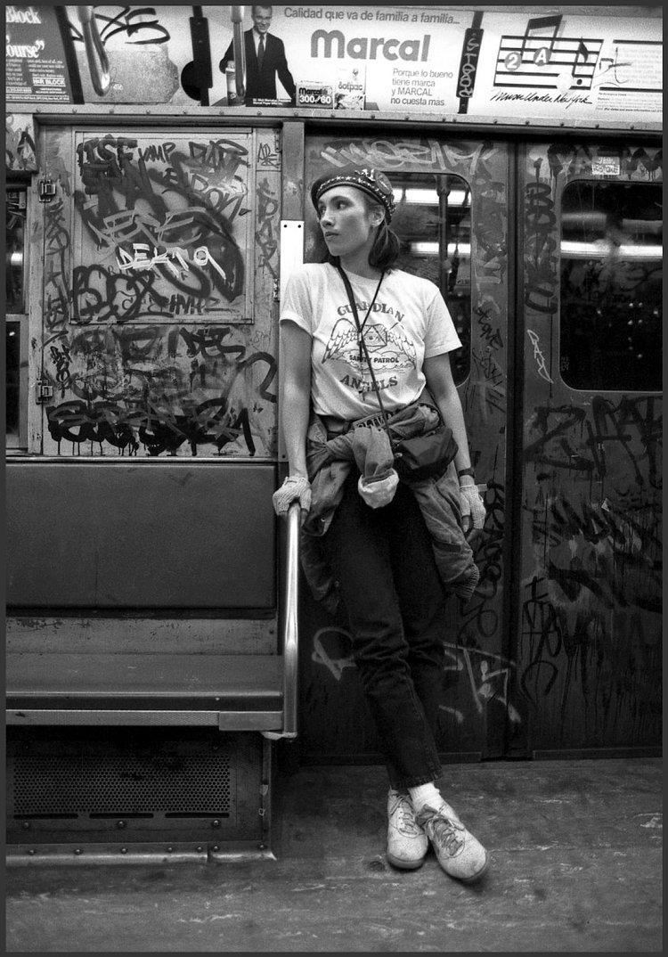 1980's: Lisa Sliwa, a member of the Guardian Angels and wife of its founder, Curtis Sliwa, patrols the subway dressed in her uniform with its signature red beret.