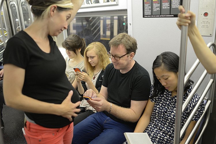 Pregnant Woman Stands on Subway While People Sit and Play with Phones | You can use this photo for non-commercial purposes if you give credit, under this <a href="https://creativecommons.org/licenses/by-nc/3.0/us/" rel="nofollow">Creative Commons license</a>. For-profit media organizations also may use this, but as editorial content only (as illustrations for stories, for example, but not as advertising). Credit must read: Richard Yeh / WNYC

We'd love to know if you're using this photo - send us an email (jkeefe@wnyc.org)!
