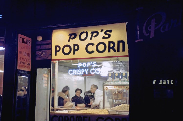 Pop corn vendor in Times Square at night with patrons inside 1946