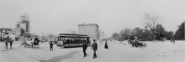 The Eighth Avenue trolley, New York City, sharing the street with horse-drawn produce wagon and an open automobile. Downtown, looking north