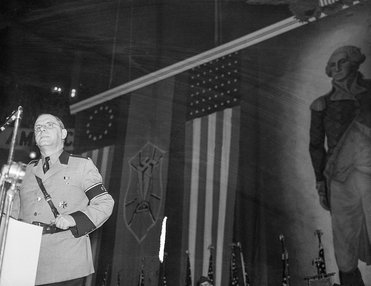 Fritz Kuhn, leader of the German American Bund, addresses the Nazi rally as protesters clash with police outside.