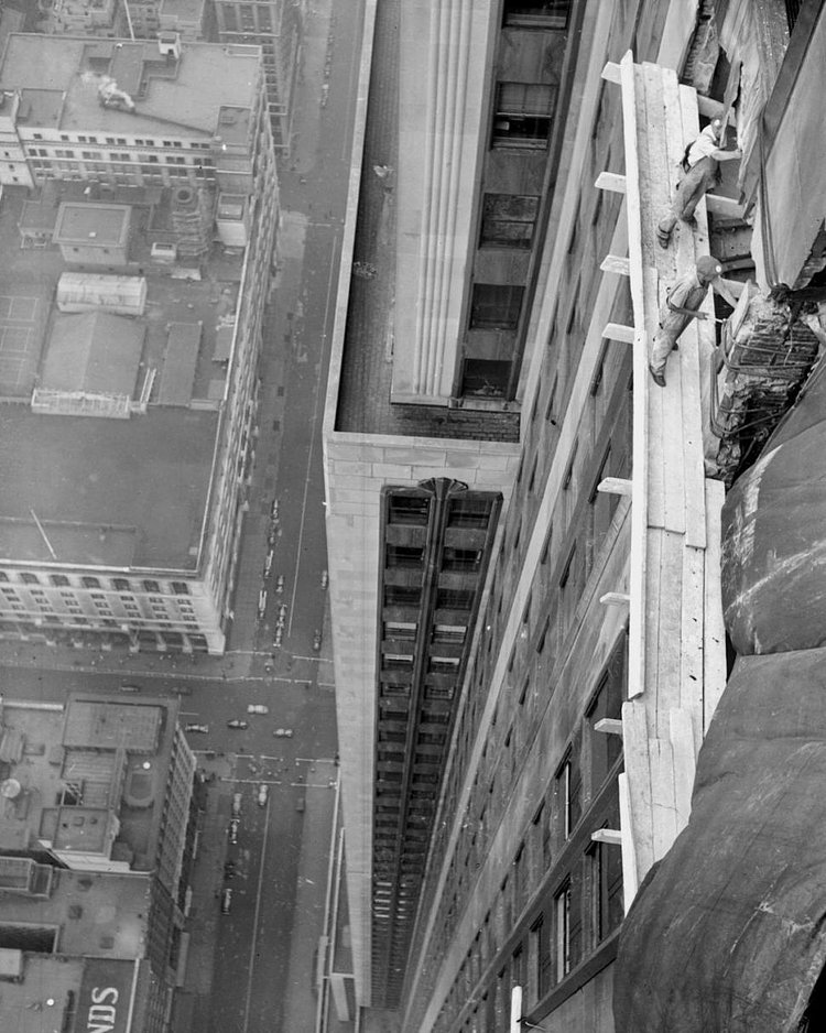 Workmen begin the costly job of repairing the damage done to the worl'd highest building the freak plane crash.