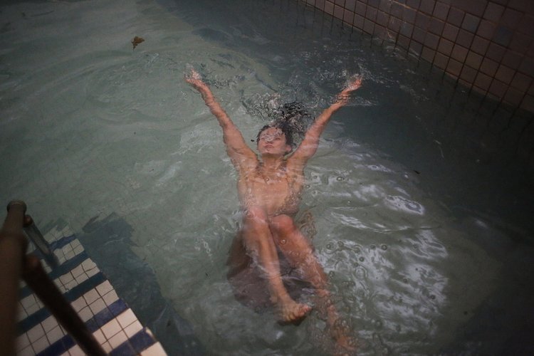 Vanessa Luczun takes a dip in the 45-degree pool in the center of the bathhouse after heating up in the saunas.