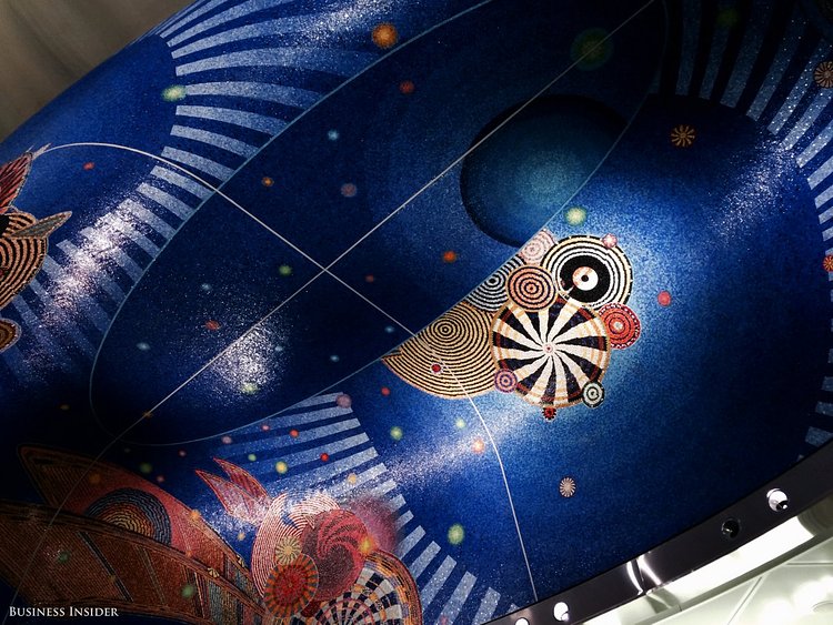 After a minute-and-a-half escalator ride (yes, that long), I reach the upper mezzanine where the turnstiles are located. Above the turnstiles is a gorgeous bright blue mosaic by artist Xenobia Bailey.