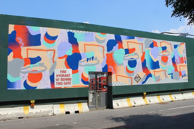 Artist Morgan Blair contented with a construction door in the middle of her mural on Dean Street.