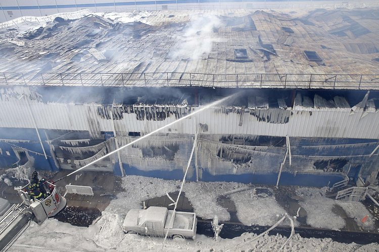 Firefighters continued pouring water on the remains of a 7-alarm fire in a warehouse on the Williamsburg waterfront