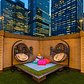 Outside, the entire deck has been covered with a soy-based artificial grass, and there are hanging cocoon chairs and couches draped with bright throws and pillows in a kaleidoscope of colors.
