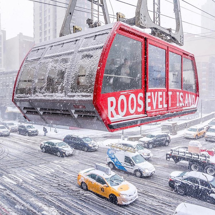 Freezing commute. The Roosevelt Island Tram above Second Avenue during the snowstorm this morning. Roosevelt Island Tramway in Manhattan, New York City