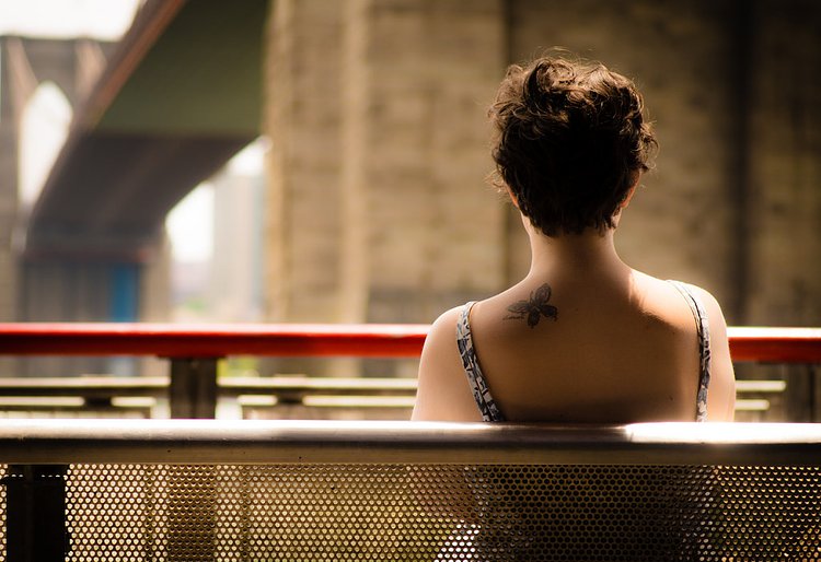 Tattooed woman under Brooklyn Bridge