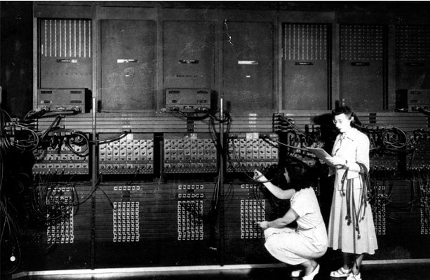 Two women wiring the right side of the ENIAC with a new program, ca. 1946. Courtesy US Army. Standing: Marlyn Wescoff, Crouching: Ruth Lichterman.