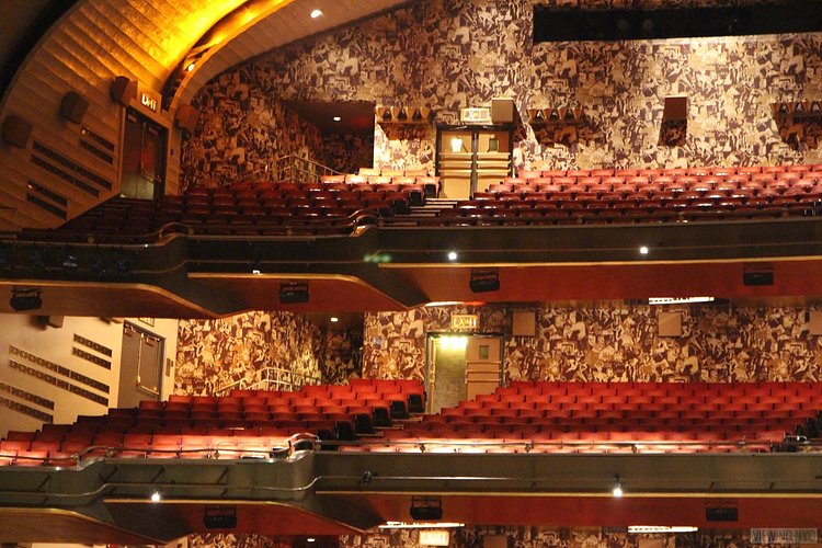 Center Stage, Looking Left and Up | Built in 1932, Radio City Music Hall is a prime example of art deco architectural style that has withstood the test of time. With tons of gold, reflective surfaces and geometric design, walking through the venue is a bit like stepping back in time. Most of the fixtures, furniture and ornamentation are original, and any replacements are exact replicas of how the theater looked 80 years ago.

Read more here: <a href="https://viewing.nyc/i-braved-a-walkthrough-of-radio-city-music-hall-meant-for-tourists/" rel="nofollow">viewing.nyc/i-braved-a-walkthrough-of-radio-city-music-ha...</a>