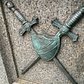 One of the bronze relief images, crossed swords and shield