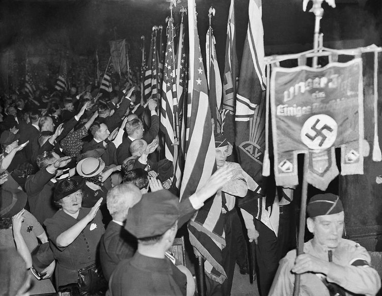 Supporters salute the banner of the German American Bund.
