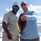 A pair of locals show off their catch from the deck of the Capitol Princess in New York Harbor.