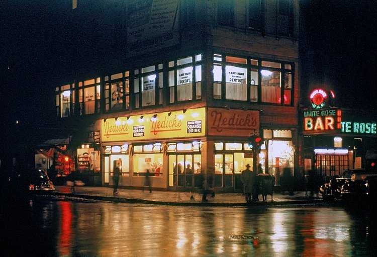 1946 Corner of the city showing a dentist's office (upstairs), Nedick's and White Rose Bar all open late at night.