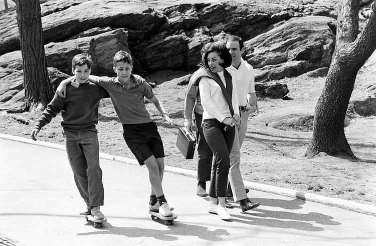 The two best friends there ever were skate arm-in-arm in the Park.