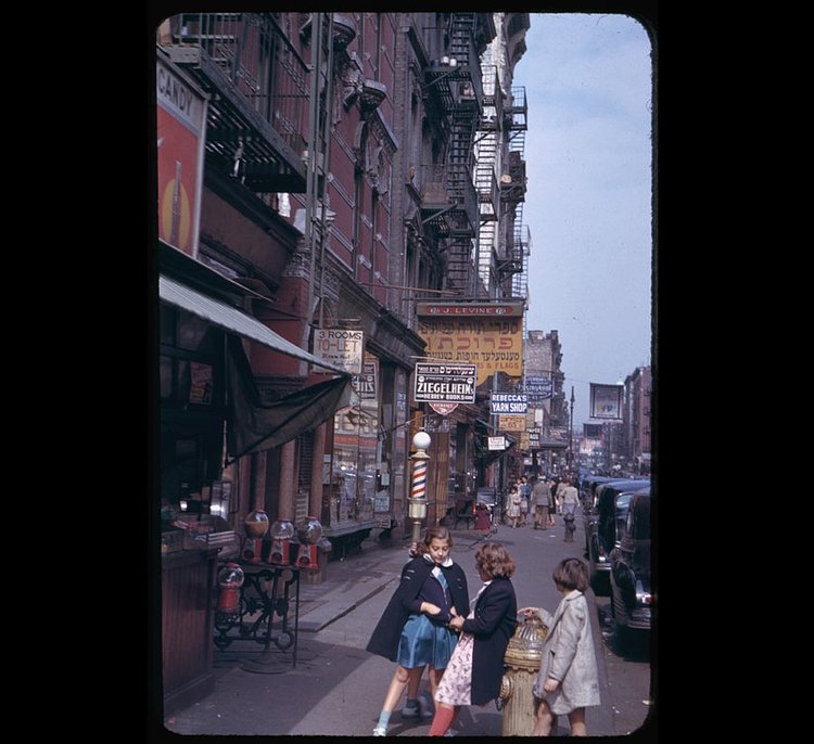 Three girls talk outside a candy shop in Lower Manhattan.