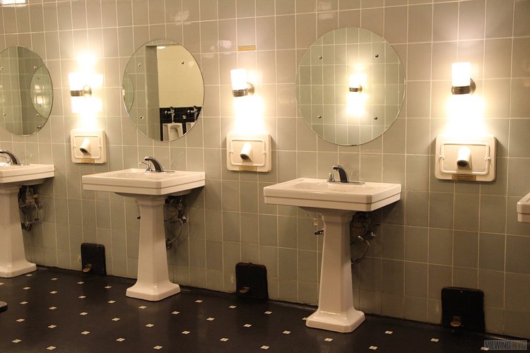 Men's Room Original Fixtures | Built in 1932, Radio City Music Hall is a prime example of art deco architectural style that has withstood the test of time. With tons of gold, reflective surfaces and geometric design, walking through the venue is a bit like stepping back in time. Most of the fixtures, furniture and ornamentation are original, and any replacements are exact replicas of how the theater looked 80 years ago.

Read more here: <a href="https://viewing.nyc/i-braved-a-walkthrough-of-radio-city-music-hall-meant-for-tourists/" rel="nofollow">viewing.nyc/i-braved-a-walkthrough-of-radio-city-music-ha...</a>