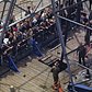 Visitors watch a working oil derrick at the petroleum exhibit.